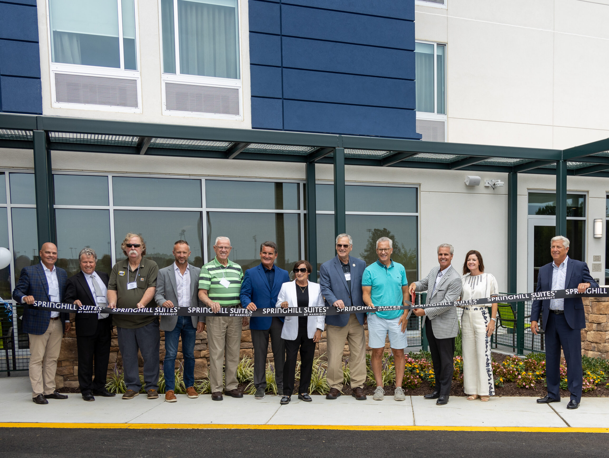 Mike Meoli along with other dignitaries cut a large ribbon in front of new SpringHill Suites hotel in Frederica, DE